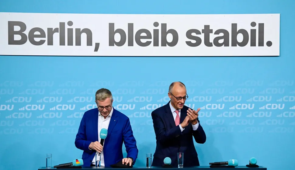 The conservative Christian Democratic Union (CDU) party's lead candidate for the Berlin state election, Stefan Evers (L) looks on as German Chancellor and leader of Germany's Christian Democratic Union (CDU) Friedrich Merz applauds during a campaign event at the CDU headquarters in Berlin, on September 17, 2026. Berlin's State elections take place on September 20, 2026. (Photo by John MACDOUGALL/AFP)