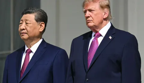 (L/R) China's President Xi Jinping and US President Donald Trump stand on the Blue Room balcony of the White House to watch an exhibition of the US Marine Corps Silent Drill Platoon, in Washington, DC, on September 24, 2026. President Xi is on a State visit to the United States from September 23 to 25. (Photo by SAUL LOEB/AFP)