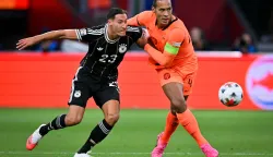 Germany's forward #23 Younes Ebnoutalib (L) fights for the ball with Netherlands' defender #04 Virgil van Dijk during the UEFA Nations League (League A, Group A2) football match between Netherlands and Germany at Johan Cruijff ArenA in Amsterdam on September 24, 2026. (Photo by NICOLAS TUCAT/AFP)
