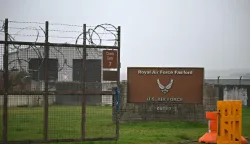 (FILES) Signage is pictured at an entrance to RAF Fairford in south west England shortly after sunrise on March 7, 2026. British police in western England on Sunday, September 27, declared a major incident and evacuated properties near a base used by the US air force after arresting several men on suspicion of explosives offences. (Photo by JUSTIN TALLIS/AFP)