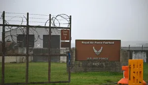 (FILES) Signage is pictured at an entrance to RAF Fairford in south west England shortly after sunrise on March 7, 2026. British police in western England on Sunday, September 27, declared a major incident and evacuated properties near a base used by the US air force after arresting several men on suspicion of explosives offences. (Photo by JUSTIN TALLIS/AFP)