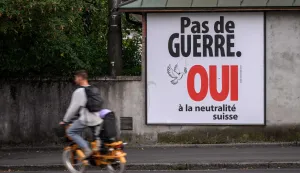 An electoral poster reads "No war, Yes to Swiss neutrality" on a street of Lausanne, western Switzerland on September 19, 2026. On September 27, 2026, Swiss citizens will vote on a popular initiative seeking to enshrine Switzerland?s perpetual and armed neutrality in the Federal Constitution and limit participation in military alliances and sanctions against belligerent states. (Photo by Fabrice COFFRINI/AFP)