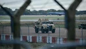 An armoured vehicle (C) patrols the interior at RAF Fairford base in Fairford, south-west England on September 28, 2026, a day after British counter-terrorism police were probing "a major" incident near the base. Armed officers detained a group of five men in the early hours after a call to emergency services about three "suspicious vehicles which appeared to be travelling towards the air base", London's Metropolitan Police said in a statement. (Photo by Ben STANSALL/AFP)
