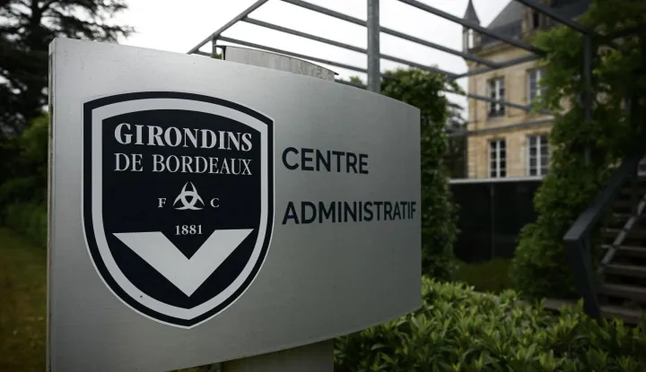 (FILES) This general view taken on May 19, 2022, shows a sign with a logo in front of the chateau of FC Girondins de Bordeaux at the club's training ground in Le Haillan, near Bordeaux, south-western France. A sale agreement between Girondins de Bordeaux?which was administratively relegated to the regional division?and the British investment fund Park Bench was signed on September 30, 2026, the club said, adding that it should thus avoid bankruptcy. (Photo by Philippe LOPEZ/AFP)
