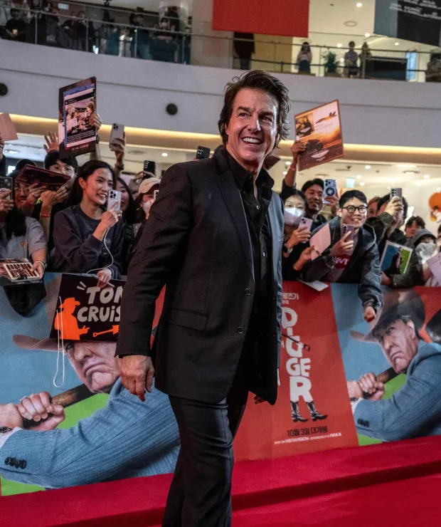 US actor Tom Cruise interacts with movie fans during the red carpet event for the film 'Digger' in Seoul on October 2, 2026. (Photo by Philip FONG/AFP)