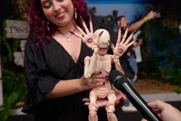 A guest holds a figure depicting the "Pale Man" during the 20th Anniversary of "Pan's Labyrinth" at the Academy Museum of Motion Pictures in Los Angeles on October 1, 2026. (Photo by Unique Nicole/AFP)