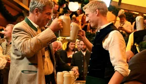 Bavaria's State Premier Markus Soeder (L) and the mayor of Munich Dominik Krause clink their beer mugs after the first barrel of beer was tapped with the traditional "O?zapft is!" (It's tapped!) to start Munich's annual beer festival, the Oktoberfest, on September 19, 2026 in Munich, southern Germany. The world's biggest beer festival Oktoberfest runs until October 4, 2026. (Photo by Tobias SCHWARZ/AFP)