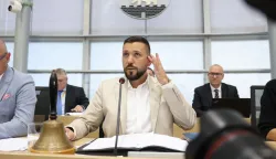 Newly elected state parliament president Tobias Rausch of the far-right Alternative for Germany (AfD) party sits at the lectern after his election during the first constituent session of the state parliament of Saxony-Anhalt in Magdeburg, eastern Germany, on October 6, 2026. Newly elected state lawmakers gather for the first time in the parliament building in the state capital Magdeburg to elect a speaker, with a candidate of the far-right Alternative for Germany (AfD) expected to win. The AfD is poised to preside over a state assembly for the first time following its landslide election victory in the eastern state of Saxony-Anhalt. The AfD took nearly 44 percent of the vote in the September 2026 state election. (Photo by Jan Woitas/POOL/AFP)