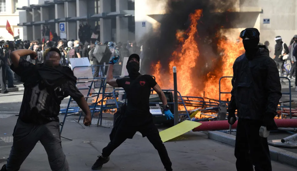 Protesters throw stones towards riot police during clashes on the sidelines of a demonstration of high-school students as part of a nationwide protest movement over learning conditions in Lyon, on October 6, 2026. Since late September, pupils have barred the entrances to hundreds of schools, complaining of teacher absences, overloaded timetables, dilapidated classrooms and buildings ill-adapted to rising temperatures, among other grievances. (Photo by Olivier CHASSIGNOLE/AFP)
