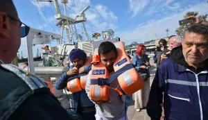 Crew members from a vessel struck by drones in Bulgaria's exclusive economic zone arrive at the port of Varna after being rescued on October 6, 2026. Bulgarian authorities launched a major search on October 6, 2026 for the missing crew of a ship that sank in the Black Sea after drones hit two vessels in what the prime minister slammed as an "absolutely unacceptable" attack. (Photo by AFP)