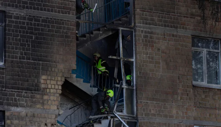 Rescuers work at a damaged school following a drone strike in Kyiv on October 1, 2026, amid the Russian invasion of Ukraine. (Photo by Tetiana DZHAFAROVA/AFP)
