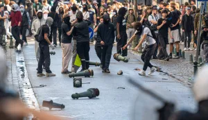 Protesters confront riot police as students gather outside several schools during a protest against education reforms and budget cuts, in Liege on October 2026. (Photo by JONAS ROOSENS/Belga/AFP)/Belgium OUT