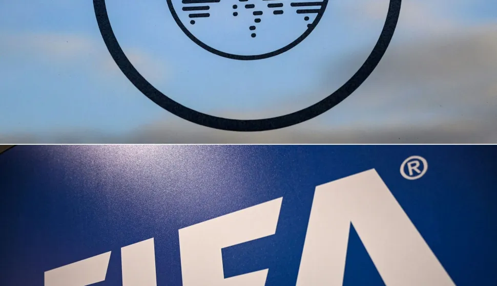 (FILES) (COMBO) This combination of pictures created on December 21, 2023 shows the UEFA logo (top) at the UEFA headquarters in Nyon on December 15, 2014 and the FIFA logo (bottom) at the FIFA Executive Football Summit in Istanbul on February 15, 2019. FIFA has accused European football's governing body UEFA of a "misinformation" campaign in its bid to access documents related to Gianni Infantino's plan to sell off parts of the World Cup. In FIFA's response in a court case in Florida, it says UEFA's attempt to force the world body to hand over the documents is also an attempt to "influence" next year's FIFA presidential election. (Photo by Fabrice COFFRINI and OZAN KOSE/AFP)