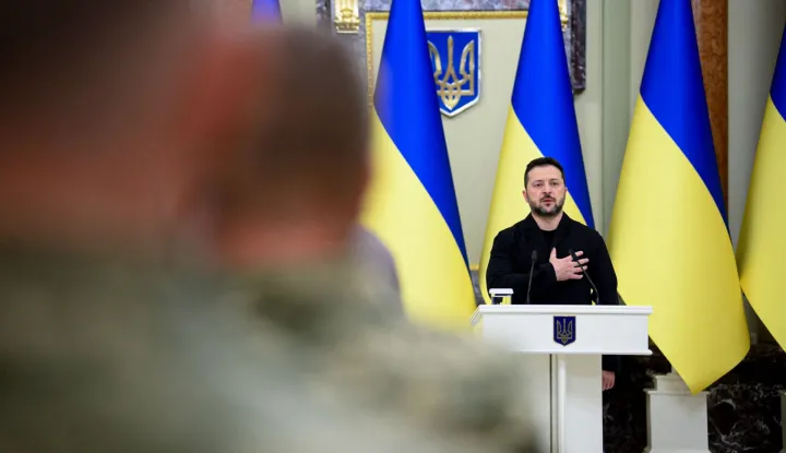 This handout photograph taken and released by the Ukrainian Presidential Press Service on October 9, 2026, shows Ukraine's President Volodymyr Zelensky singing Ukraine's national anthem during a ceremony to present housing certificates to Heroes of Ukraine and the families of fallen soldiers awarded the title posthumously in Kyiv, amid the Russian invasion of Ukraine. (Photo by Handout/UKRAINIAN PRESIDENTIAL PRESS SERVICE/AFP)