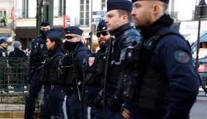 French Republican Security Corps (CRS - Compagnies Republicaines de Securite) police officers stand in line during a demonstration called by several public teachers unions of Paris' Ile-de-France region against the 2026 state budget and planned teaching jobs cuts, in Paris on February 17, 2026. (Photo by Charlotte SIEMON/AFP)