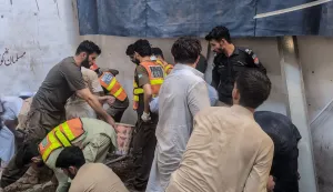 This photograph taken and released by the Khyber Pakhtunkhwa province's Emergency Service (Rescue 1122) on October 15, 2026 shows rescue workers during a search operation after a roof collapsed at a school in Peshawar. Sixteen pupils and a teacher were killed on October 15 after a roof collapsed at a school in the northwest Pakistani city of Peshawar, emergency services said. (Photo by Handout/Khyber Pakhtunkhwa province's Emergency Service (Rescue 1122)/AFP)/RESTRICTED TO EDITORIAL USE - MANDATORY CREDIT "AFP PHOTO /Khyber Pakhtunkhwa province's Emergency Service (Rescue 1122)/ HANDOUT/" - NO MARKETING NO ADVERTISING CAMPAIGNS - DISTRIBUTED AS A SERVICE TO CLIENTS