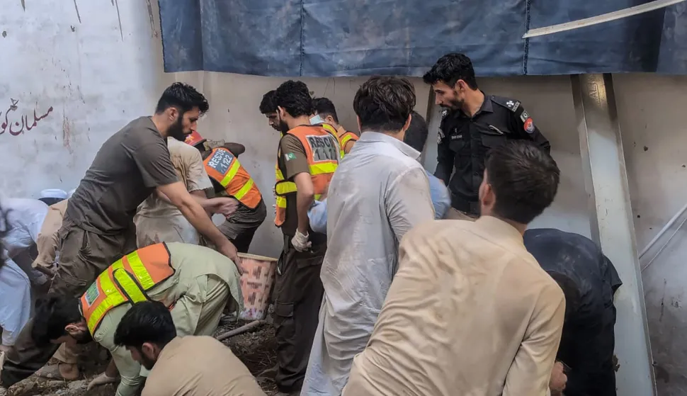 This photograph taken and released by the Khyber Pakhtunkhwa province's Emergency Service (Rescue 1122) on October 15, 2026 shows rescue workers during a search operation after a roof collapsed at a school in Peshawar. Sixteen pupils and a teacher were killed on October 15 after a roof collapsed at a school in the northwest Pakistani city of Peshawar, emergency services said. (Photo by Handout/Khyber Pakhtunkhwa province's Emergency Service (Rescue 1122)/AFP)/RESTRICTED TO EDITORIAL USE - MANDATORY CREDIT "AFP PHOTO /Khyber Pakhtunkhwa province's Emergency Service (Rescue 1122)/ HANDOUT/" - NO MARKETING NO ADVERTISING CAMPAIGNS - DISTRIBUTED AS A SERVICE TO CLIENTS