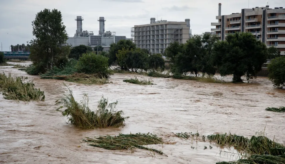 The swollen Besos River flows through Sant Adria de Besos following torrential rains on the outskirts of Barcelona, on October 4, 2026. Torrential rains battering eastern Spain have left two dead and kept the city of Barcelona and its surrounding areas on high alert, authorities said today, warning of the risk of flooding and overflowing rivers. (Photo by Josep LAGO/AFP)