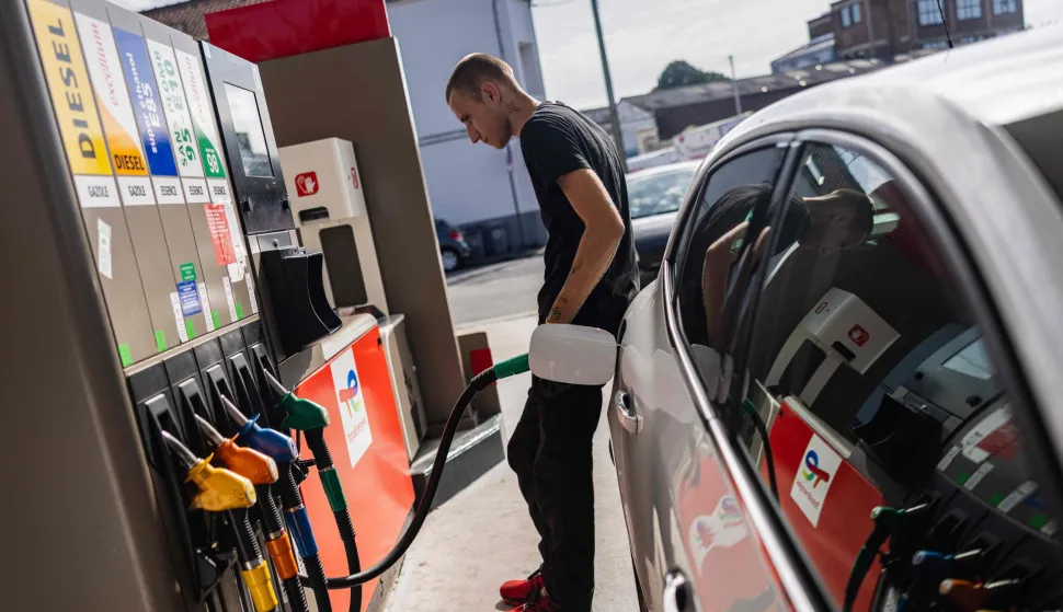 (FILES) A motorist fills his car at a Total Energies petrol station in Faches-Thumesnil near Lille, northern France on August 10, 2023. TotalEnergies commits to lowering the price of a liter of off-road diesel by 20 cents according to CEO of TotalEnergies Patrick Pouyanne. (Photo by Sameer Al-DOUMY/AFP)