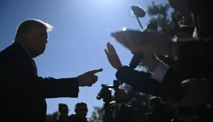 US President Donald Trump speaks to members of the press before boarding Marine One on the South Lawn of the White House in Washington, DC, on October 19, 2026. President Trump is traveling to Wichita, Kansas to hold a campaign rally ahead of the midterm elections. (Photo by Brendan SMIALOWSKI/AFP)