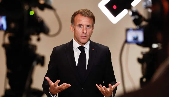 France's President Emmanuel Macron speaks to members of the media on the day of the 9th Annual One Planet Sovereign Wealth Funds (OPSWF) Summit in Lusail on October 21, 2026. The French president is undertaking a tour of key energy suppliers in the Gulf in an effort to secure oil and diesel and bring down prices in France. (Photo by Benoit Tessier/POOL/AFP)