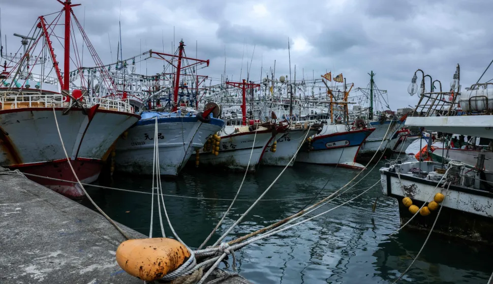 Fishing boats are moored at a fishing harbour as Typhoon Champi approaches Taiwan in Keelung on October 22, 2026. A powerful typhoon headed towards Taiwan on October 22, triggering the cancellation of dozens of flights and prompting warnings for locals to prepare for heavy rain, strong winds and giant waves. (Photo by I-Hwa Cheng/AFP)