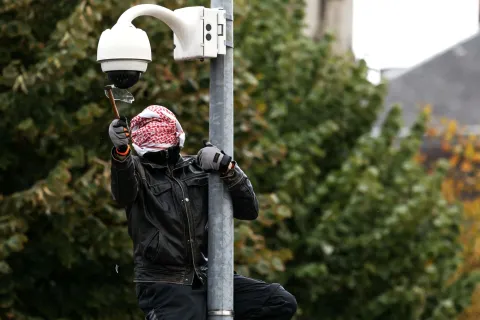 TOPSHOT - A protester breaks a surveillance camera during a demonstration in favor of purchasing power, the protection of public services, and fiscal and social justice, in Strasbourg, eastern France on October 24, 2026 as part of a nationwide call for mobilisation bringing together former members of the Yellow Vest movement, labor unions, high school and university students. Protests by high school students over learning conditions sparked a movement that has since spread nationwide, fuelled by broader anger over the rising cost of living. About 70,000 security personnel will be deployed on October 24, 2026, Interior Minister said at a news conference, warning that calls for violence and looting were circulating on social media. (Photo by ROM?O BOETZLE/AFP)