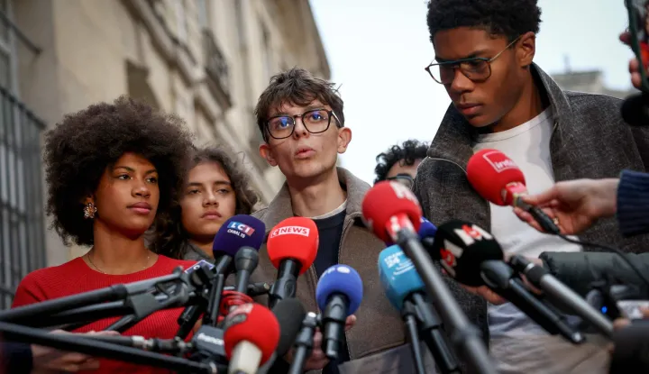 Representatives of secondary school pupils organisations Les Lyceens vice-president Louis Letoublon (C) and Renouveau Lycee president Nathanael Combary (R) speak to the press as they leave the Hotel Matignon after a meeting with French Prime Minister on October 26, 2026 in Paris, after another weekend of protests over the state of the country's high schools and the cost of living, with pressure mounting on the government to deliver promised reforms to the education system. Students at France's high schools have been campaigning for better conditions in their schools and a reform of the education for more than a month. But the police response to their demonstrations, which included blockades of school, has been fiercely criticised as heavyhanded by parents, students, rights groups and opposition politicians. Several teenage protesters have been seriously injured and thousands arrested. (Photo by Anne-Christine POUJOULAT/AFP)