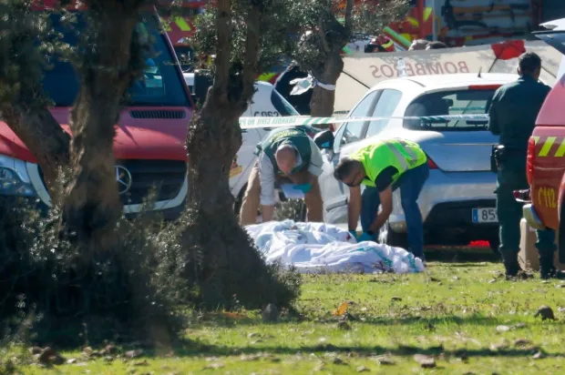 Civil guards stand near victims the site of a train crash between a high speed Renfe AVE train and Iryo train around 150kms south of Madrid between Urda and Los Yebenes in the province of Toledo, on October 28, 2026. A high-speed train collision south of Madrid killed 64 people and injured scores more on Wednesday, with the toll likely to rise, authorities said in Spain's second such disaster this year. (Photo by Oscar DEL POZO/AFP)