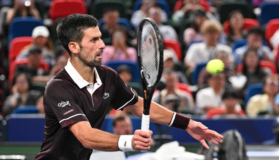 Serbia's Novak Djokovic hits a return to Poland's Hubert Hurkacz during their men's singles match at the Shanghai Masters tennis tournament in Shanghai on October 9, 2026. (Photo by Hector RETAMAL/AFP)
