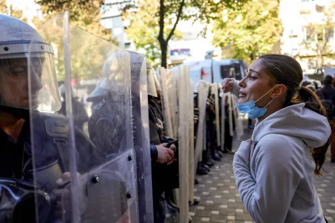 A protester faces riot police officers during an anti-government demonstration in central Tirana on October 20, 2026, after a week of violent anti-government protests. Albanian Prime Minister on October 20, 2026 blamed a "hybrid war" for fuelling unrest in his country, after a week of violent anti-government demonstrations in Tirana. Demonstrators have repeatedly clashed with police as months of protests escalate, driven by fresh demands for better university conditions, anger over corruption and renewed calls for Prime Minister's resignation. (Photo by Adnan Beci/AFP)