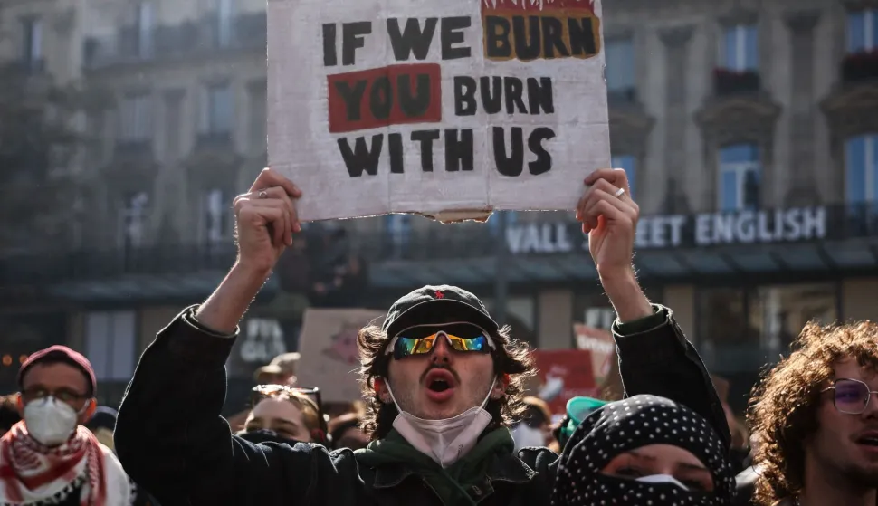 A protesters holds a placard during a demonstration to protest against the "high cost of living", at Place de la Republique in Paris on October 17, 2026 as part of a nationwide call for mobilisation bringing together various groups expressing their anger: former "Yellow Vests", secondary school and university students, climate activists and even farmers. After weeks of student protests, France faces broader, nationwide demonstrations on October 17, 2026 over the cost of living, setting up a potentially fraught six months heading into a presidential election. A police source told AFP that authorities estimated nearly 200,000 people could take part, with 40,000 in Paris. (Photo by Kiran RIDLEY/AFP)